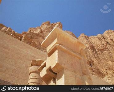 Low angle view of columns in front of a stone wall, Egypt