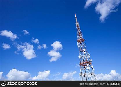 Low angle view of communication tower against blue sky