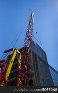 Low angle view of crane at construction site against blue sky, Minneapolis, Hennepin County, Minnesota, USA