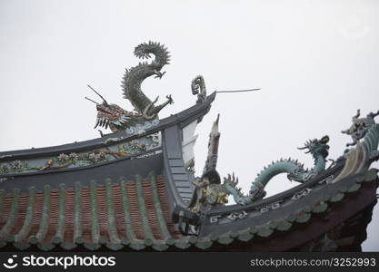 Low angle view of dragon sculptures on the roof of a temple
