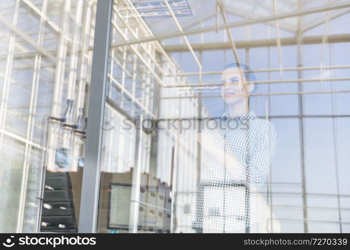Low angle view of farmer seen through window at distribution storehouse