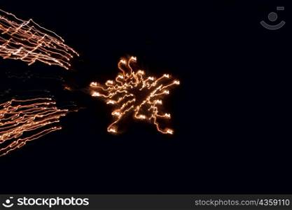 Low angle view of fire crackers exploding in the night sky