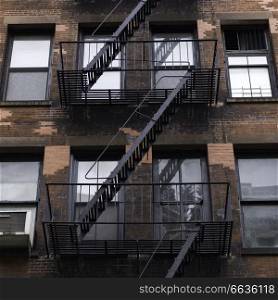 Low angle view of fire escape on apartment building, Lower Manhattan, New York City, New York State, USA