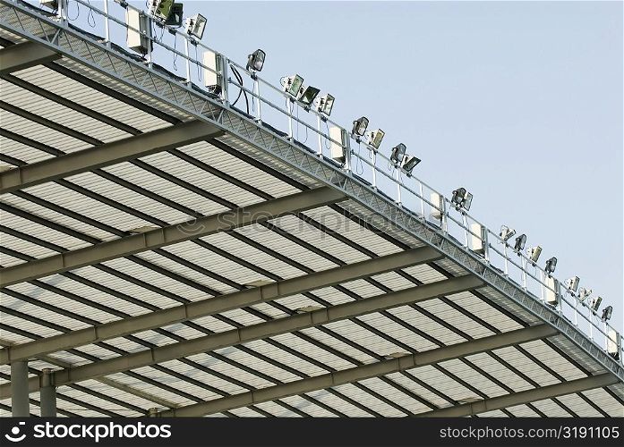 Low angle view of flood lights on a stadium roof