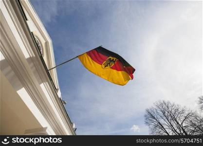 Low angle view of German flag on government building against cloudy sky; Tallinn; Estonia; Europe