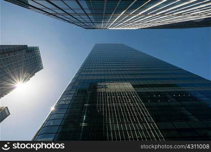 Low angle view of glass fronted skyscrapers, London, UK