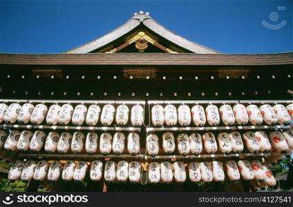 Low angle view of lanterns hanging from the roof of a temple, Kiyomizu Temple, Kyoto, Japan