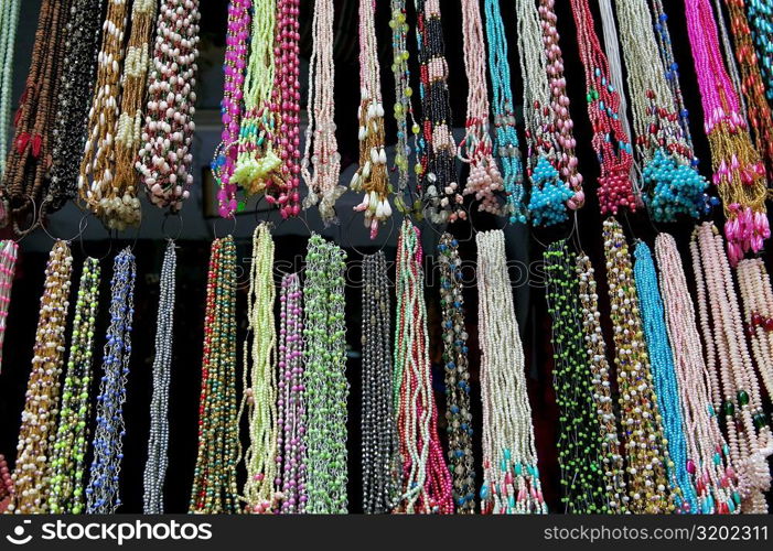 Low angle view of necklaces at a store, Pushkar, Rajasthan, India