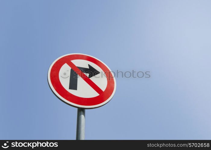 Low angle view of no right turn sign against clear sky
