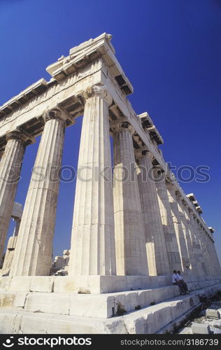 Low angle view of old ruin colonnades in a shrine, Parthenon, Athens, Greece