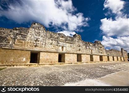 Low angle view of old ruins of a building, Cuadrangulo De los Pajaros, Uxmal, Yucatan, Mexico