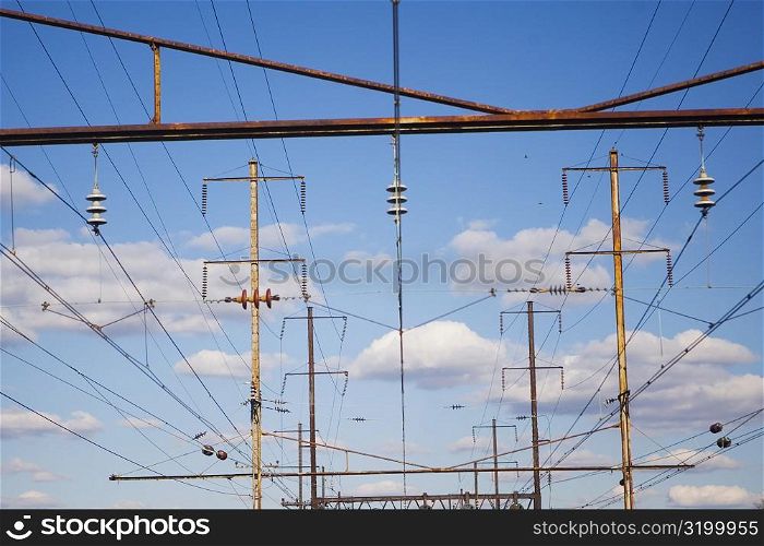 Low angle view of power cables over railroad tracks