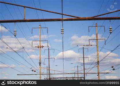 Low angle view of power cables over railroad tracks