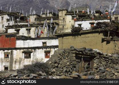Low angle view of prayer flags on houses in a town, Muktinath, Annapurna Range, Himalayas, Nepal