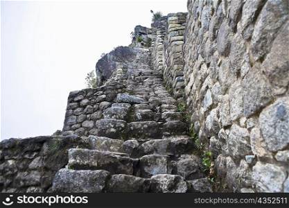 Low angle view of ruined steps, Aguas Calientes, Mt Huayna Picchu, Machu Picchu, Cusco Region, Peru