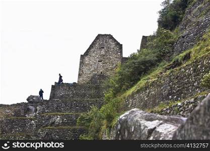 Low angle view of ruins, Aguas Calientes, Mt Huayna Picchu, Machu Picchu, Cusco Region, Peru
