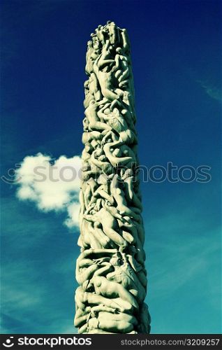 Low angle view of sculptures carved on a column, Gustav Vigeland Sculpture Park, Oslo, Norway