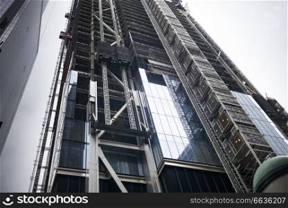 Low angle view of skyscraper under construction, New York City, New York State, USA