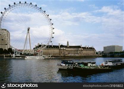 "Low angle view of "The Eye" Ferris wheel and Thames River, London, England, United Kingdom"