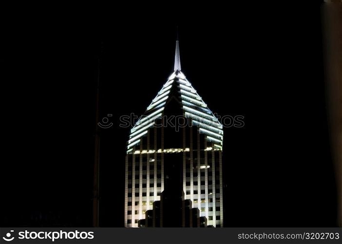 Low angle view of the top of a building lit up at night, Prudential Tower, Chicago, Illinois, USA