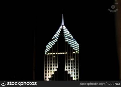 Low angle view of the top of a building lit up at night, Prudential Tower, Chicago, Illinois, USA