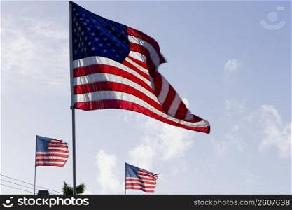 Low angle view of three American flags fluttering