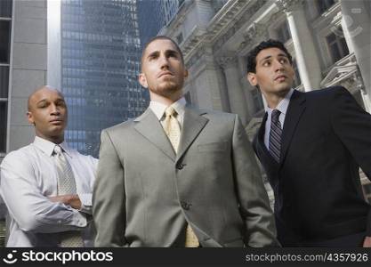Low angle view of three businessmen standing