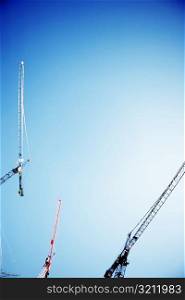 Low angle view of three cranes against the sky, Washington DC, USA