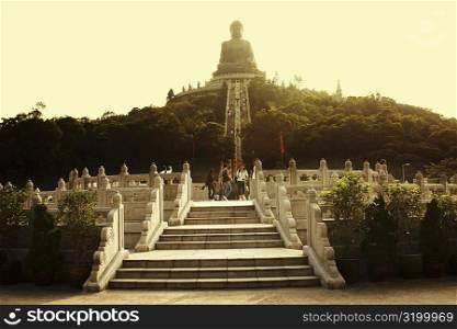 Low angle view of tourists visiting a monastery, Tian Tan Buddha, Po Lin Monastery, Ngong Ping, Lantau, Hong Kong, China