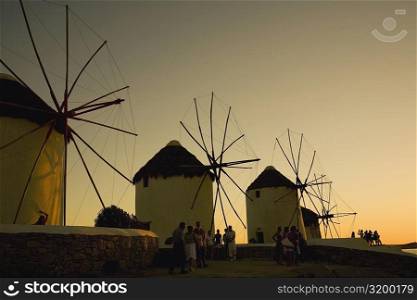 Low angle view of traditional windmills at dusk, Mykonos, Cyclades Islands, Greece