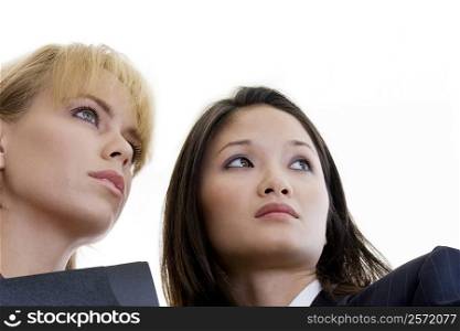 Low angle view of two businesswomen looking away