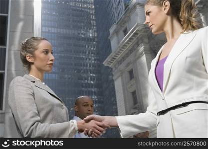 Low angle view of two businesswomen shaking hands