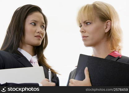 Low angle view of two businesswomen standing face to face