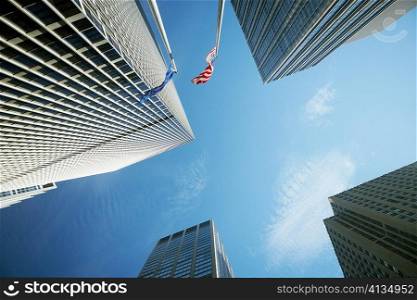 Low angle view of two flags with skyscrapers, New York City, New York State, USA