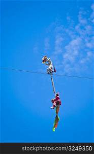 Low angle view of two people performing stunt on a rope, Emerald Valley, Huangshan, Anhui Province, China