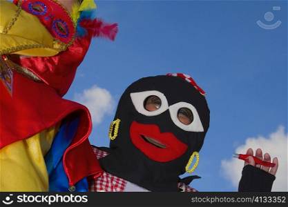 Low angle view of two people wearing masks