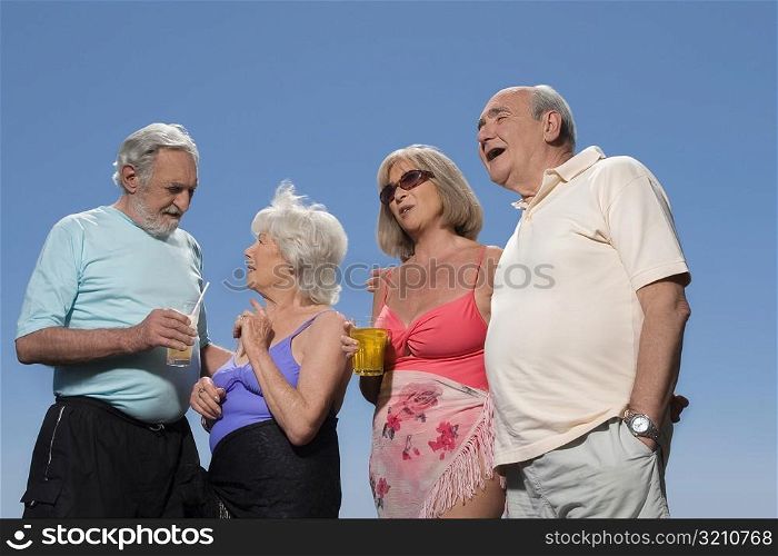 Low angle view of two senior couples standing together