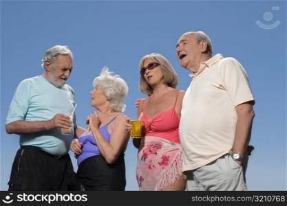 Low angle view of two senior couples standing together