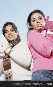 Low angle view of two young women standing