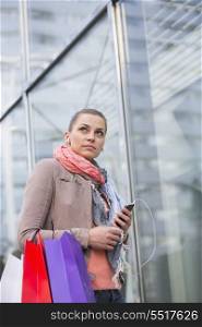 Low angle view of woman listening to music while shopping