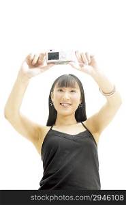 Low angle view of young woman holding a camera