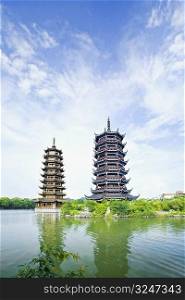 Low angle view pagoda at the waterfront, Sun and Moon Pagoda, Banyan Lake, Guilin, Guangxi Province, China