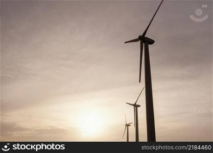 low angle wind turbines sunset generating energy