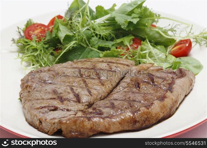 Low-carb meal of grilled rump steak with a home-grown salad mix and cherry tomatoes