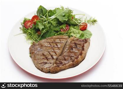 Low-carb meal of grilled rump steak with a home-grown salad mix and cherry tomatoes