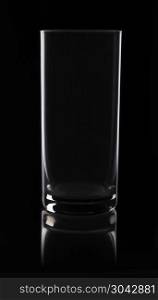 Low-key photography: glass on black background. a glass without ornaments, illuminated in low-key in the studio, photo for product purposes.