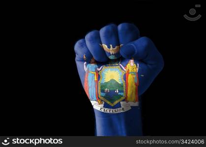 Low key picture of a fist painted in colors of american state flag of new york