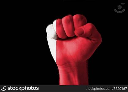 Low key picture of a fist painted in colors of bahrain flag