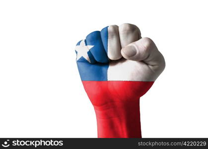 Low key picture of a fist painted in colors of chile flag