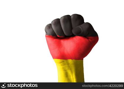 Low key picture of a fist painted in colors of germany flag